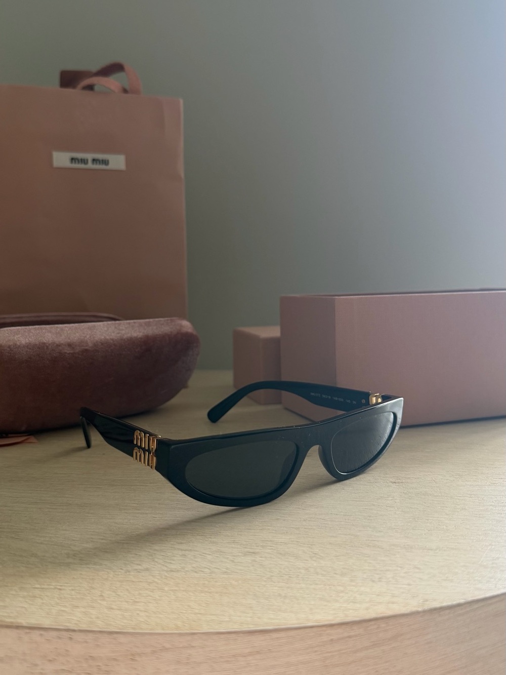 Miu Miu Black Cat-Eye Sunglasses with Gold Temple Accents